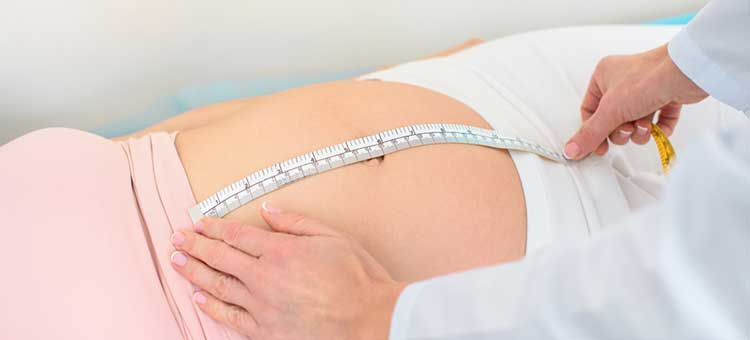 kobieta w 9 tygodniu ciąży - pomiar brzucha