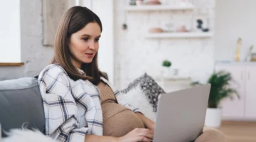 Mama przeglądająca szpitale do porodu na laptopie