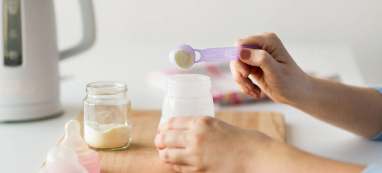 Mama przygotowująca mleko początkowe dla swojego dziecka