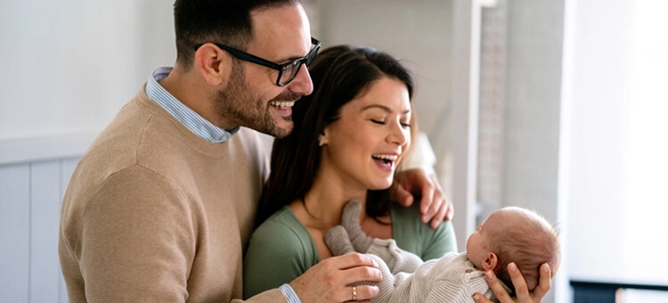 Rodzice adopcyjni trzymający niemowlę na rękach