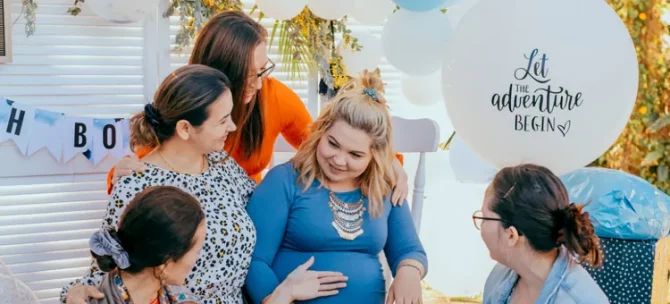 Radosne grono kobiet wspiera przyszłą mamę podczas baby shower z okazji przyjścia na świat maluszka