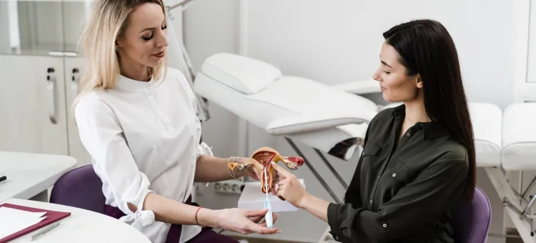 Specjalistka tłumaczy pacjentce funkcjonowanie spirali antykoncepcyjnej na modelu anatomicznym układu rozrodczego